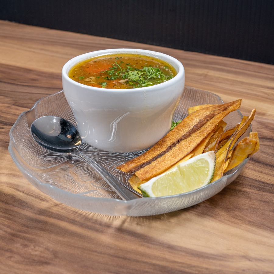 Soup with plantain chips and lime
