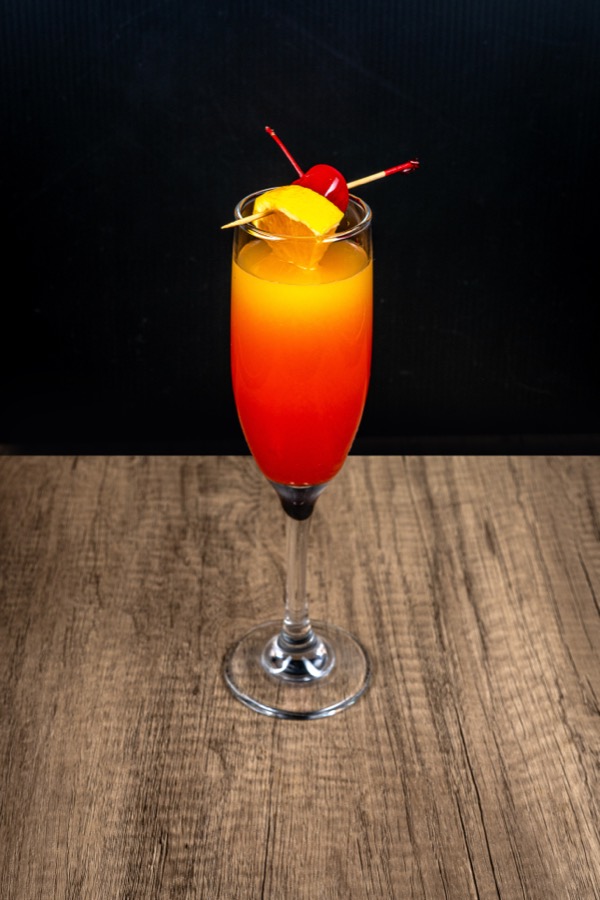 Layered red and orange cocktail in a tall glass