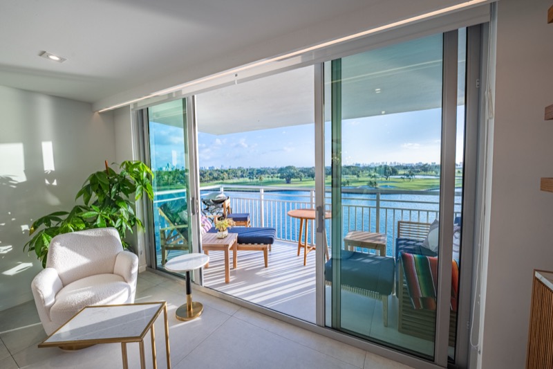 Balcony view over the water from a condo living room